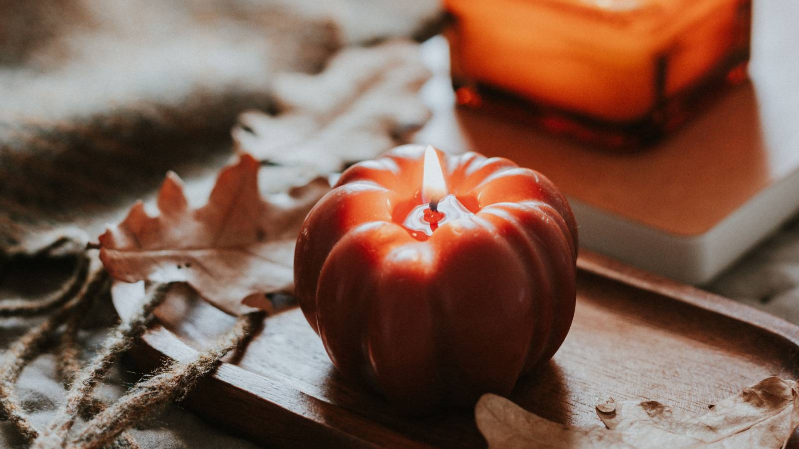 A burning candle shaped like a tomato