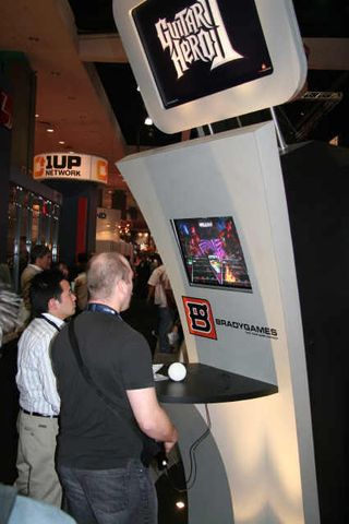 Two E3 attendees play some cords on Guitar Hero II