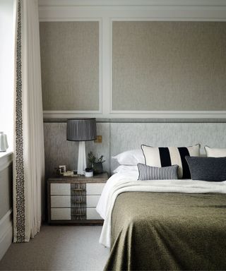 bedroom with cream walls and dark green bedspread