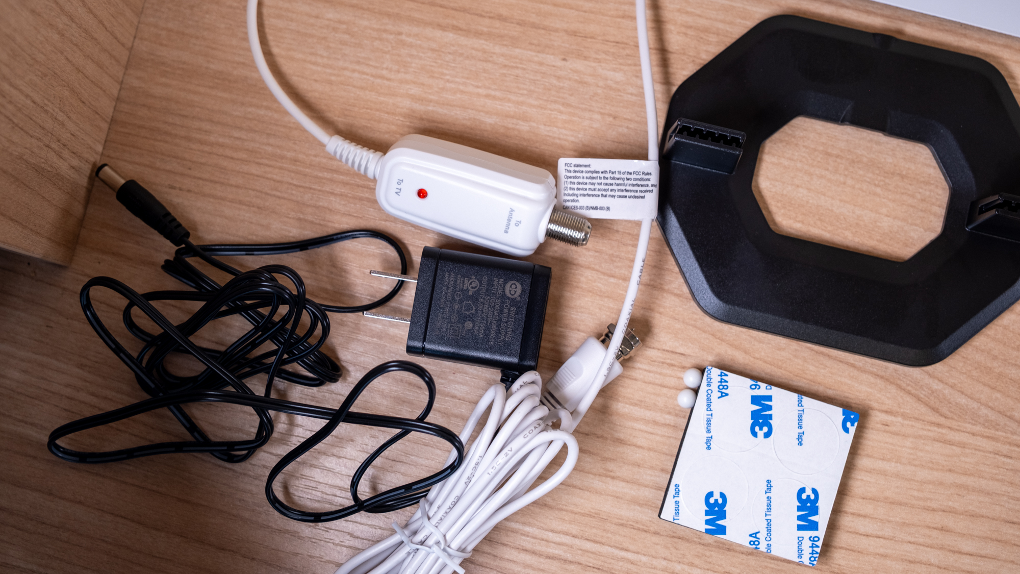 The Best Buy Essentials Ultra-Thin Amplified HDTV Antenna on a desk.
