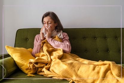 unwell woman blowing her nose