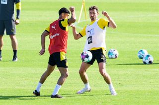 Mahmoud Dahoud and Thomas Delaney of Borussia Dortmund battle for the ball during a recent training session.