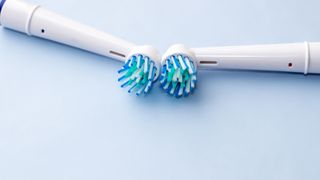 Two electric toothbrush heads laying side by side