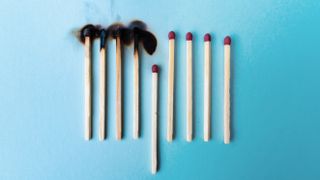 burnt and unburnt matches on blue background