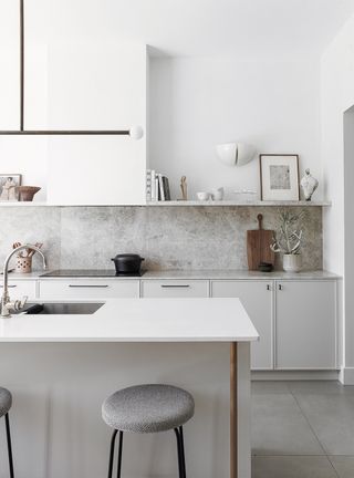 white kitchen with modern pendant light over the island