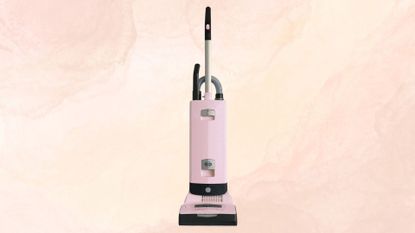 The SEBO Automatic X7 Vacuum on a pink and yellow marble background