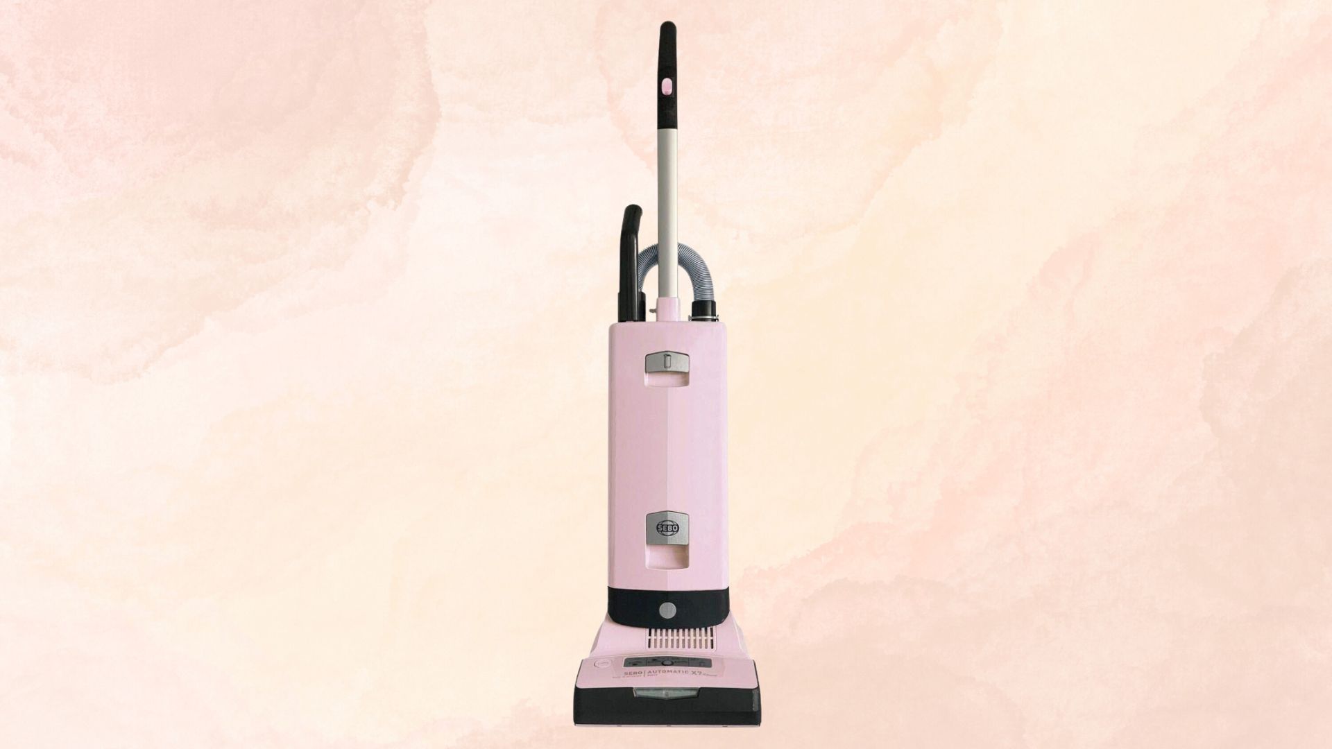 The SEBO Automatic X7 Vacuum on a pink and yellow marble background