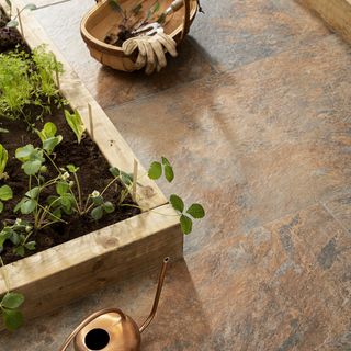 Brown effect patio with planter and gardening tools