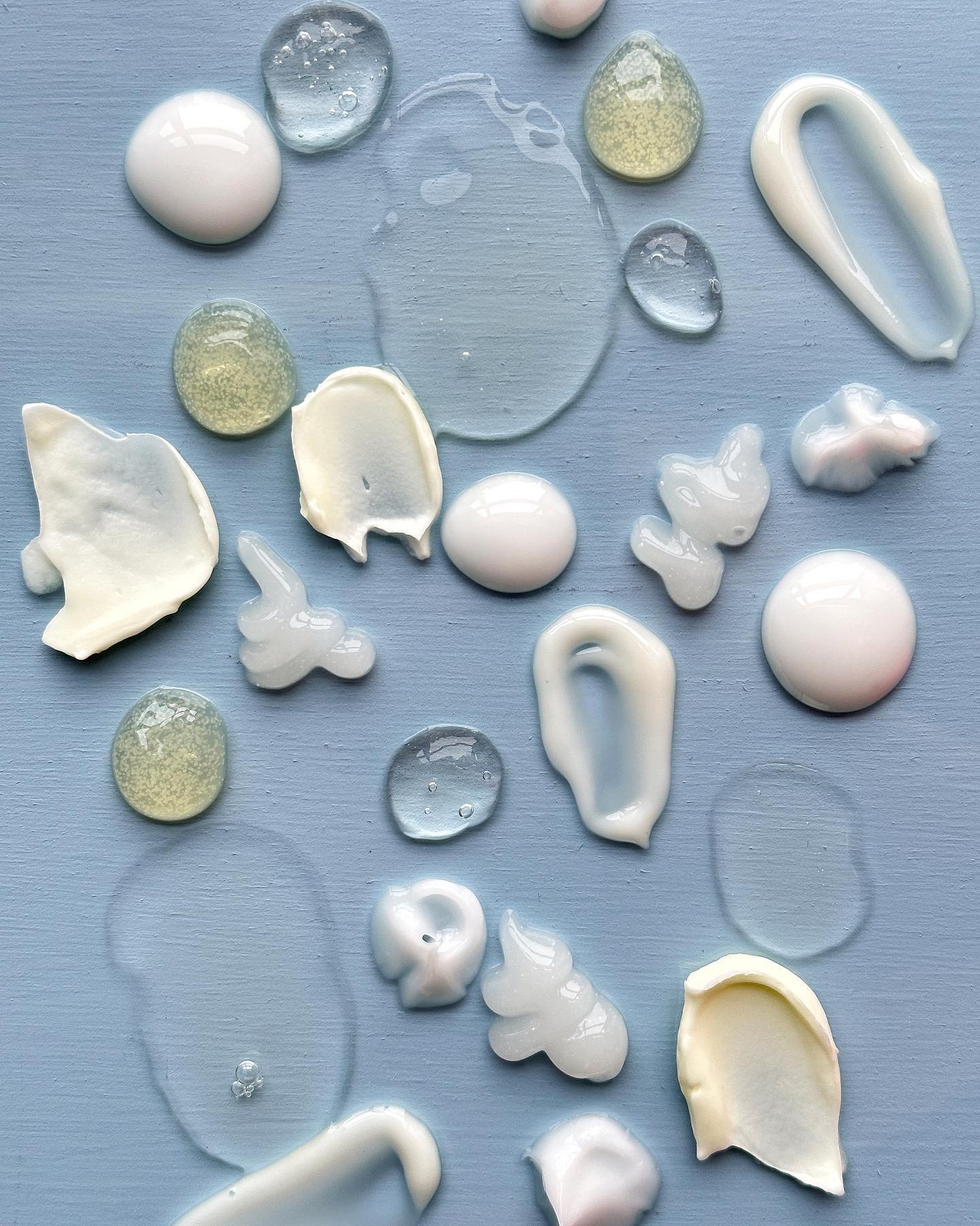 Skincare product textures against a blue background