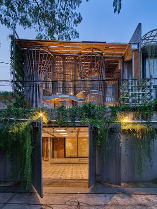 Concrete, bamboo and nature mix at RAW architecture's live/work space, seen here the entrance