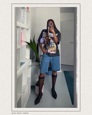 @the_oluwaseun wearings jorts with a printed tee and pointed mules