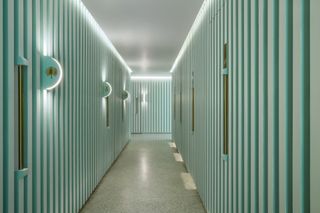 Pastel green striped corridor with lighting at Infinity Wellbeing, Bangkok