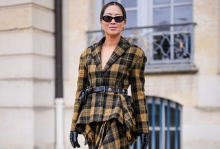 Woman in plaid jacket and skirt