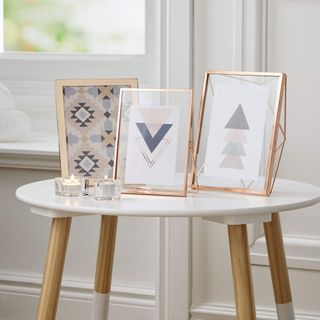 table with photo frames and candle