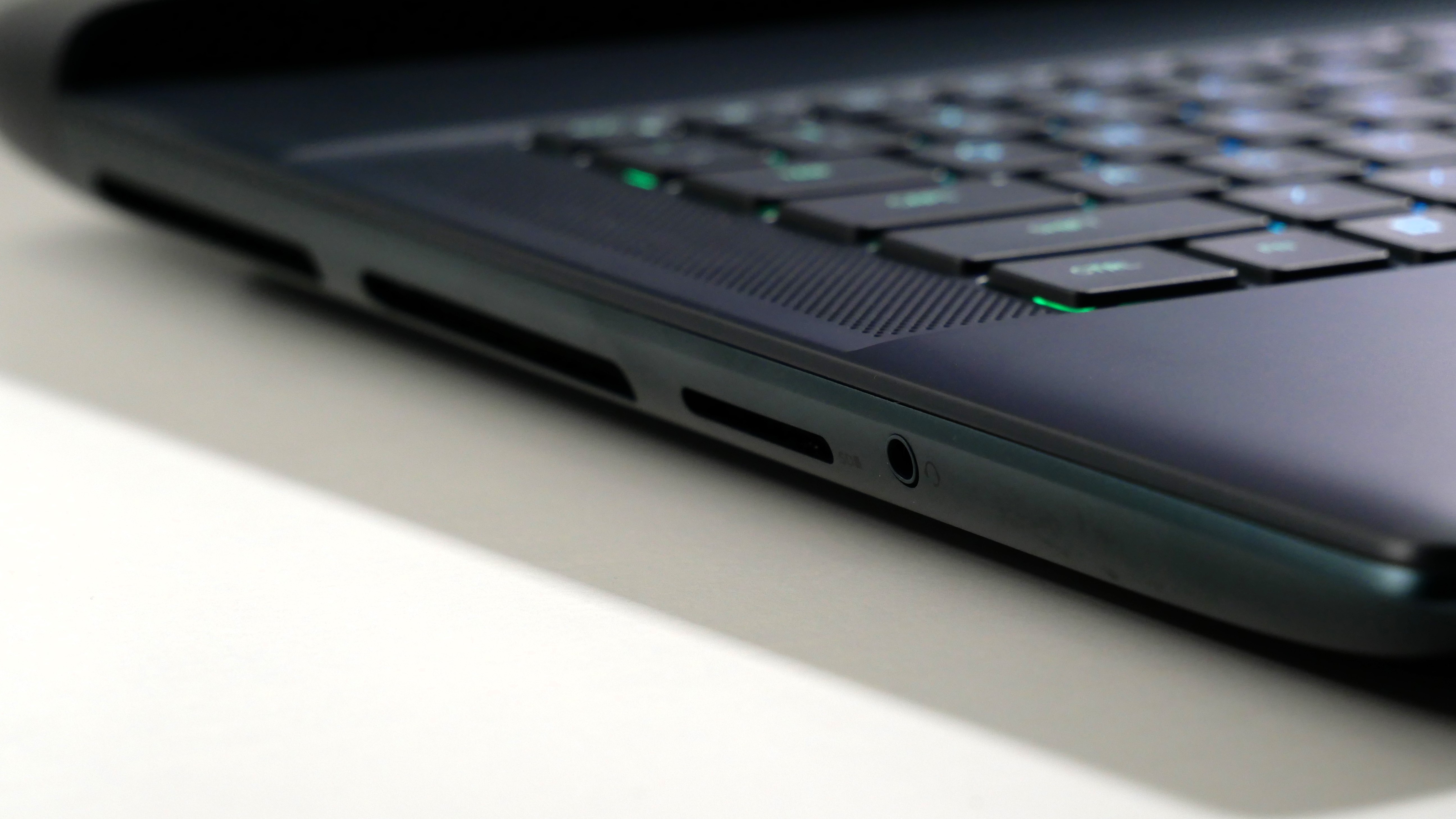 Alienware 16 Area-51 (RTX 5080) open on a white desk, highlighting the ports on the left.