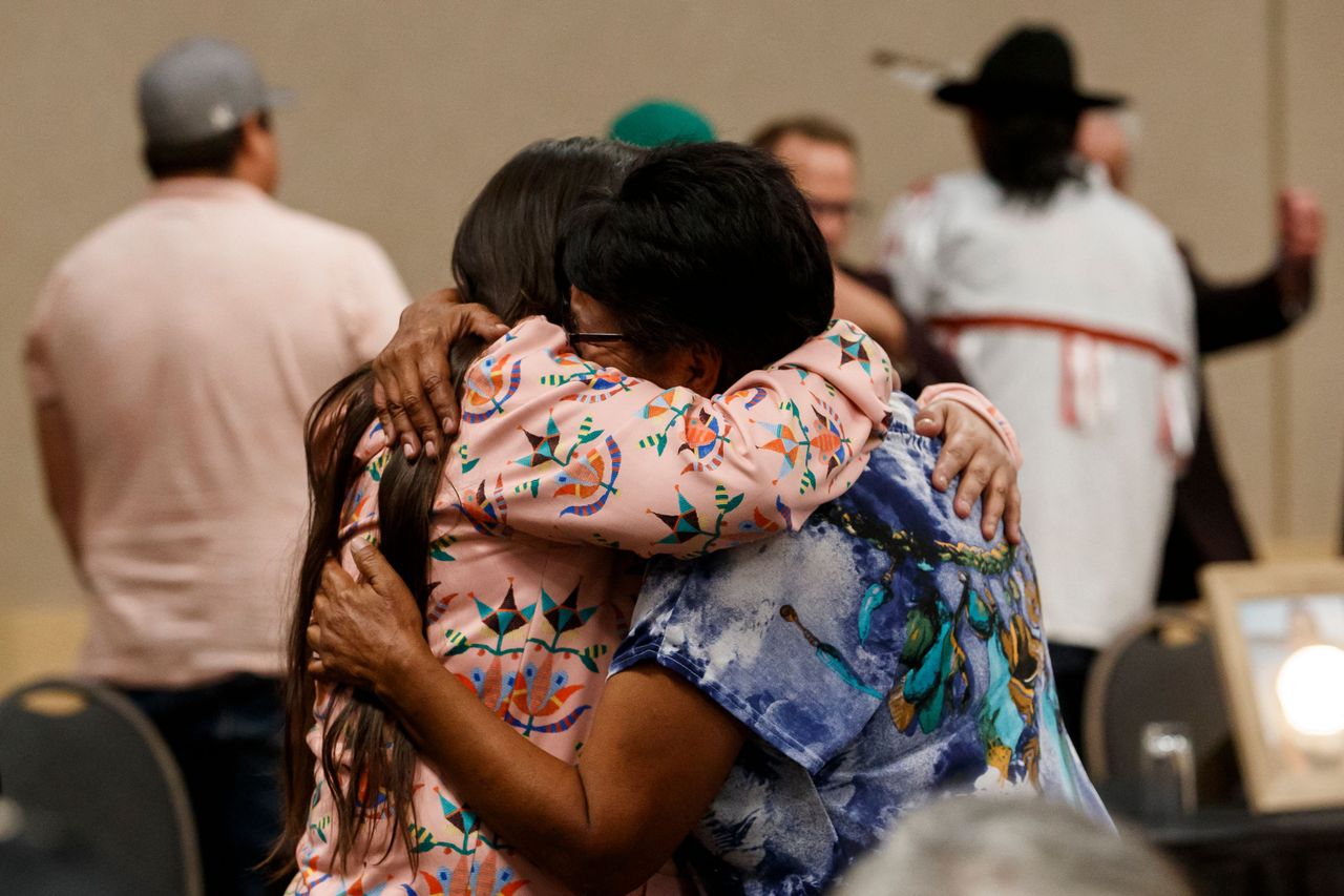 Two individuals share an emotional embrace.