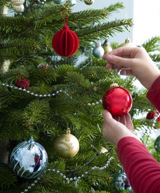 Decorating Christmas tree with ornaments