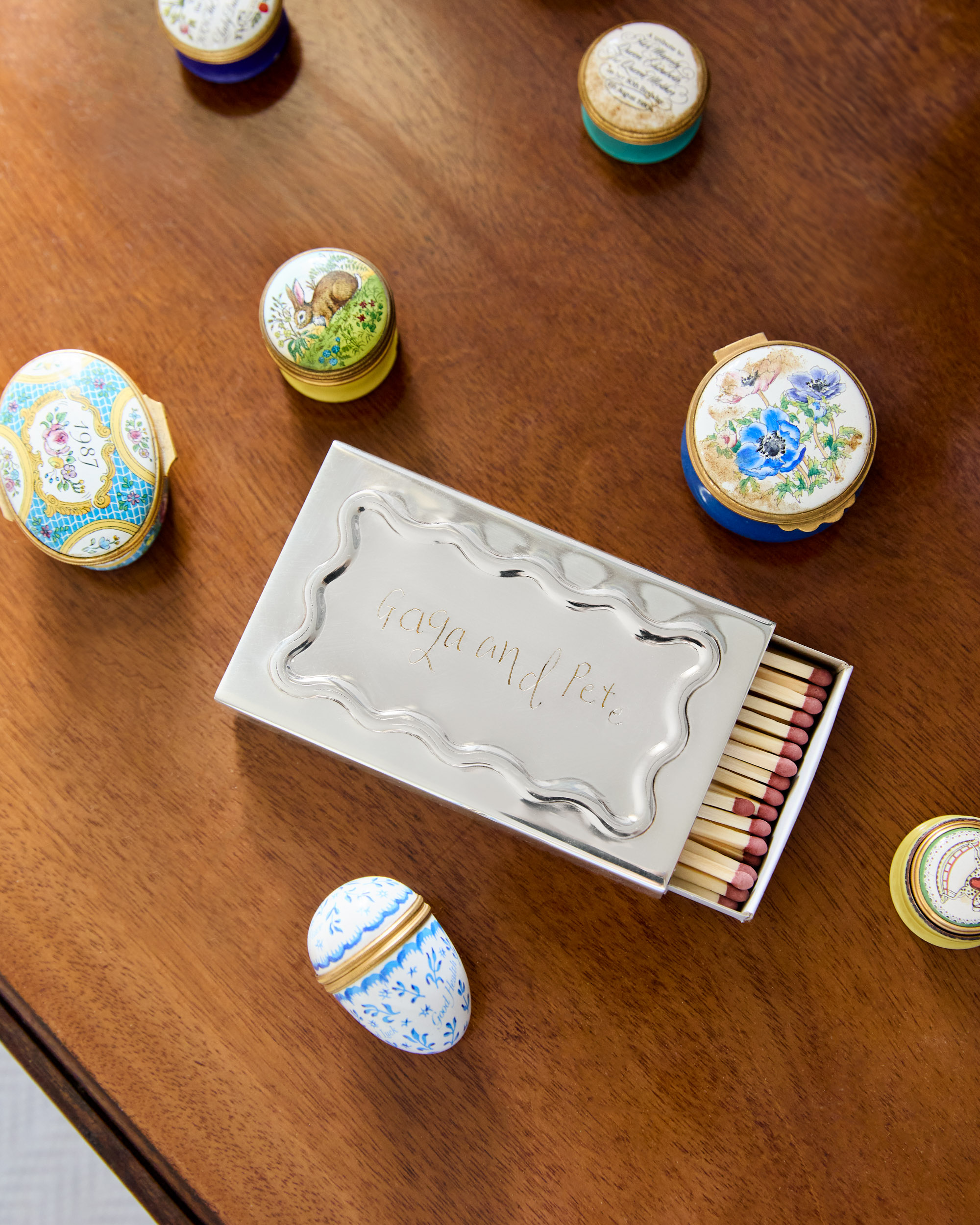 MG&amp;amp;Co. - Silver Wave Engraved Matchbox Sleeve on a wooden table filled with other collectibles.