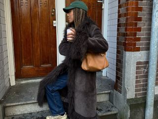 Amaka Hamelijnck in a brown Charlotte Simone coat