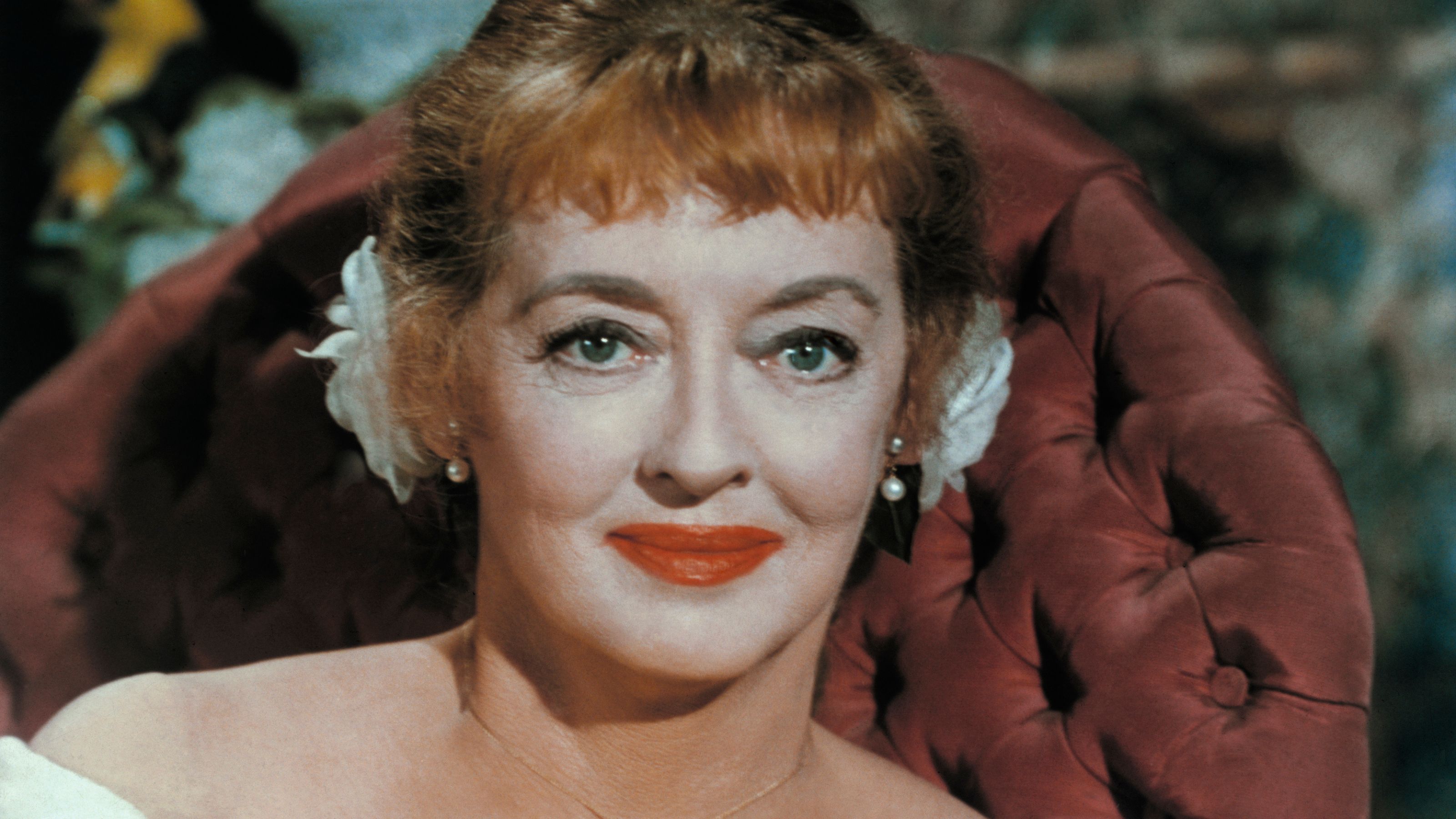 bette davis on a red chair