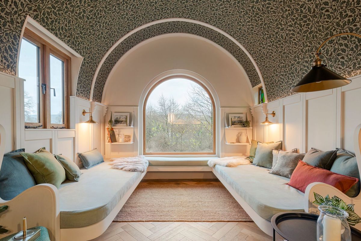 A u shaped cream sofa inside the living area of the caravan