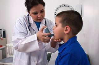 A doctor treats a young boy with asthma