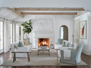 a white living room with textured white wall art