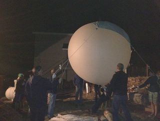 In Bishop, Calif., students led by astronomer Tony Phillips inflate a weather balloon to carry a NASA camera into the stratosphere to photograph the Lyrid meteor shower on April 22, 2012.