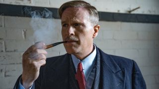 Cary Elwes pensively smoking a pipe in The Ministry of Ungentlemanly Warfare.
