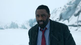 John Luther (Idris Elba) walks through the snow in Luther: The Fallen Sun, a new Netflix movie coming March 10, 2023