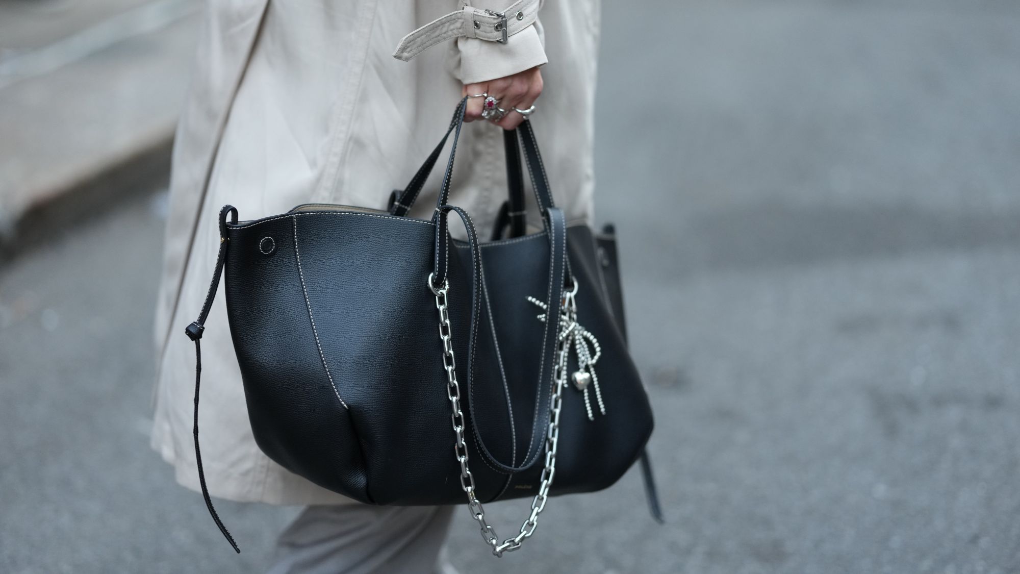 street style shots of woman carrying black tote bag