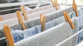 Towels and clothes being air dried on indoor rack