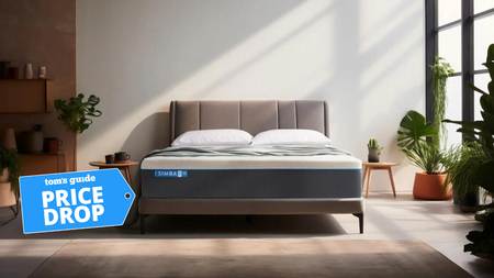 The Simba Hybrid Pro Mattress on a bed in a white bedroom on a bright winter's morning with a blue price drop badge overlaid on the bottom left hand corner of the image