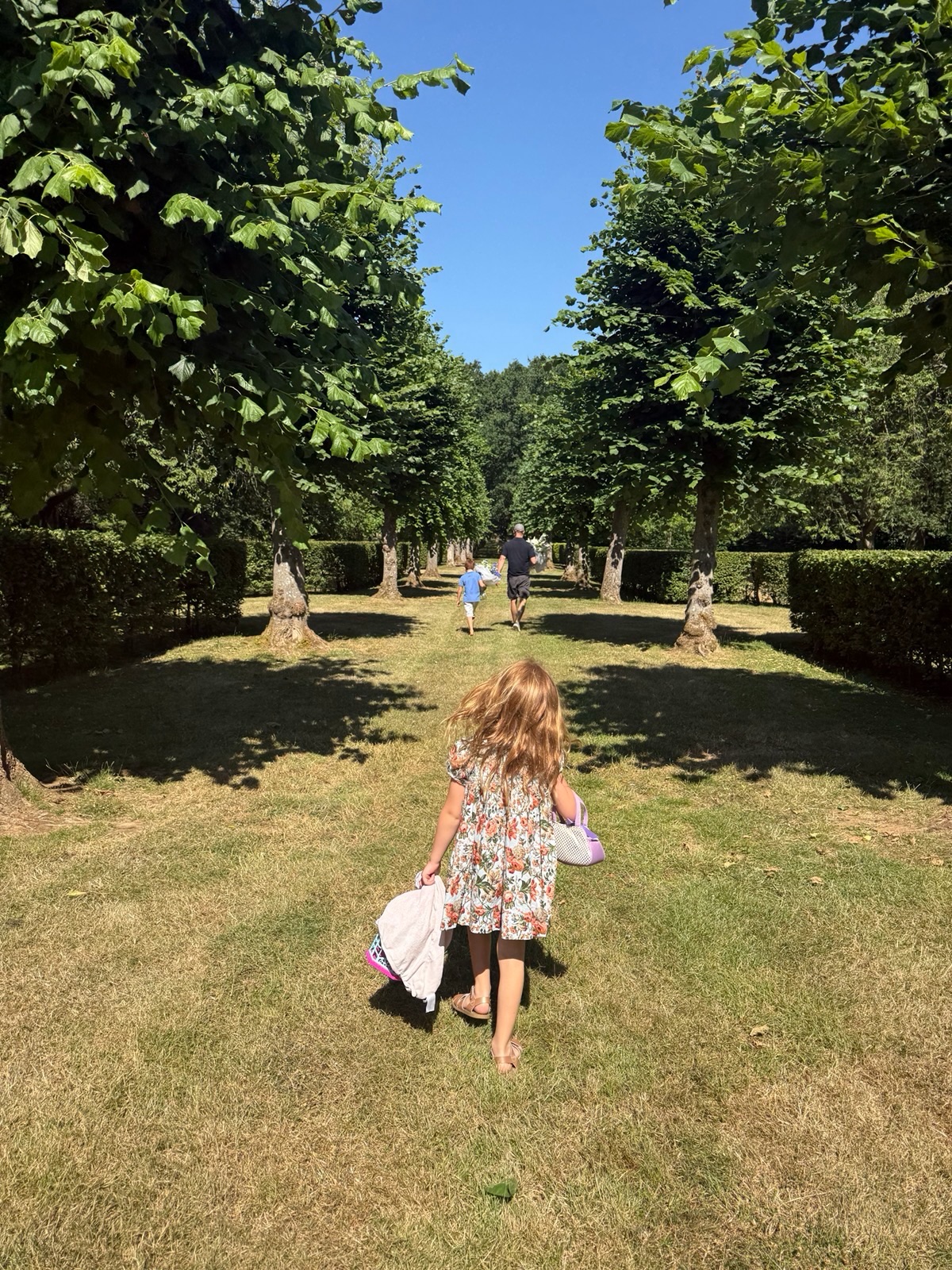 Prince Harry, Prince Archie and Princess Lilibet at walking in the grass at Althorp