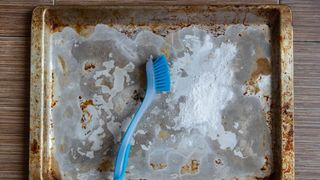 Washing soda to clean baking sheet with brush