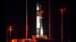 A Rocket Lab Electron rocket on its Virginia launch pad at night