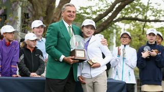 Lucy Li is given the trophy after winning the Girls 10-11 category at the National Finals of the Drive, Chip and Putt Championship