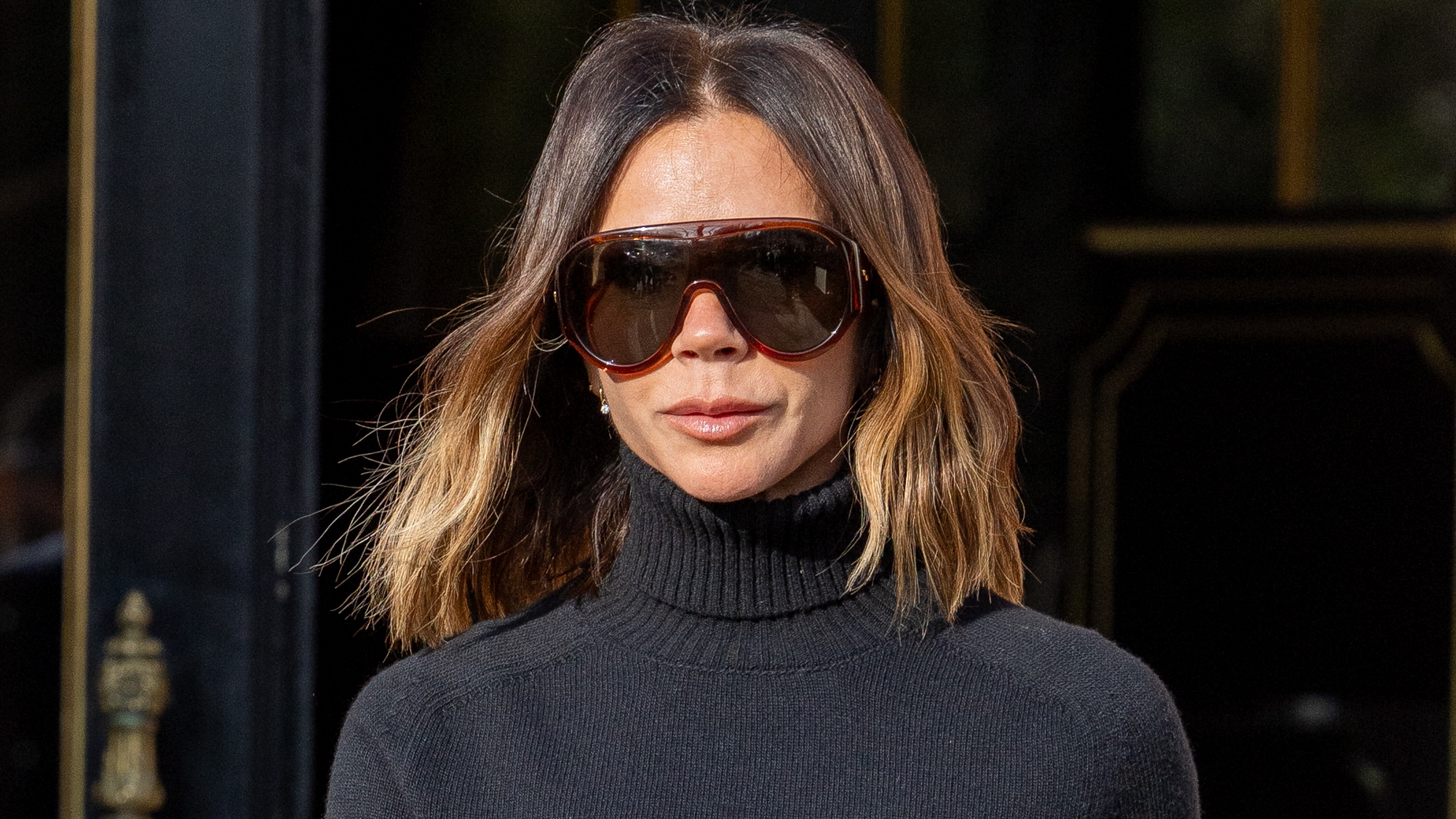 Victoria Beckham is seen wearing a roll neck jumper and sunglasses on March 07, 2025 in Paris