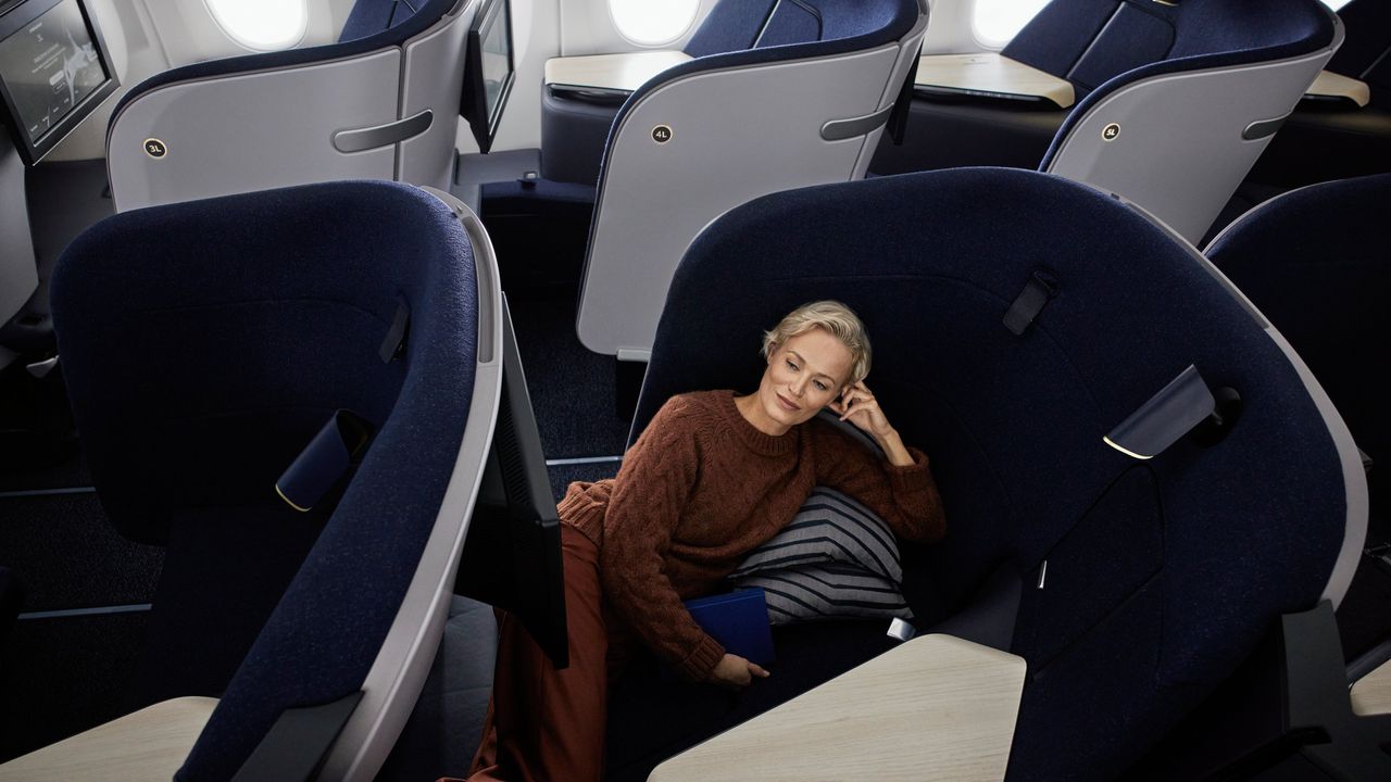 woman lies back in new Finnair Business Class seat by PriestmanGoode