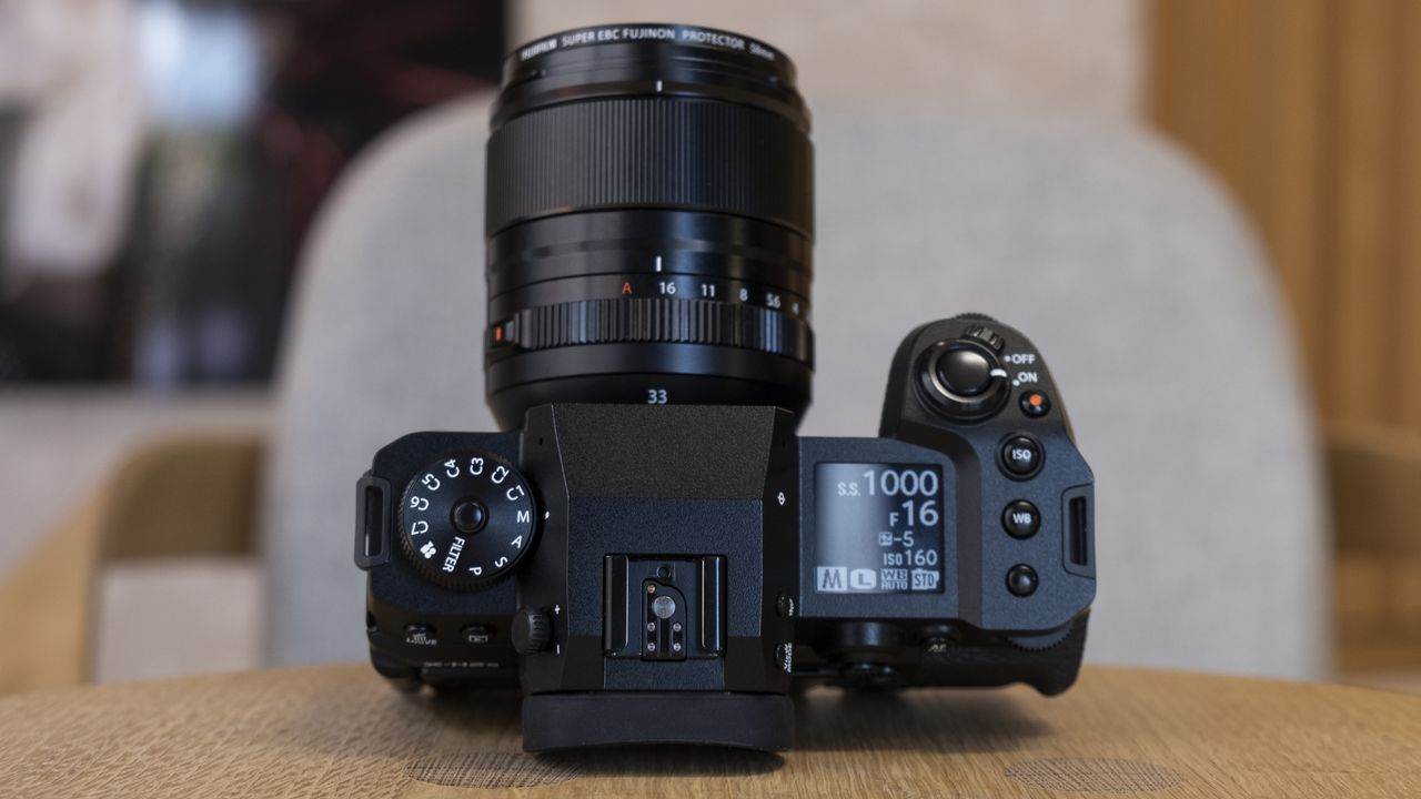 The Fujifilm X-H2S camera on a wooden table