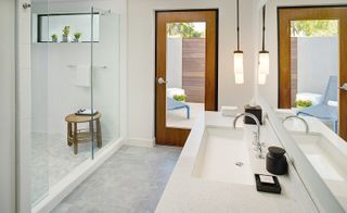 bathroom with shower area and white washbasin