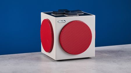 A beige, red and black 8BitDo Retro Cube 2 Bluetooth speaker