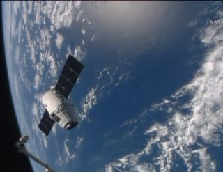 A SpaceX Dragon space capsule floats serenely in orbit near the International Space Station with the Earth as a dazzling backdrop in this view from the station on April 20, 2014 as the Dragon cargo ship delivered nearly 5,000 lbs. of supplies to the outpo