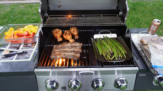 The Cuisinart Four Burner Dual Fuel Gas Grill cooking meat and veggies