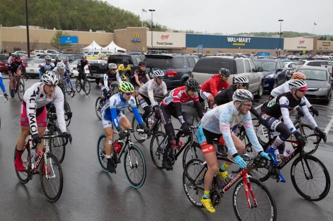The pro men's field rolls out from the start of stage two near a Fayetteville Walmart.