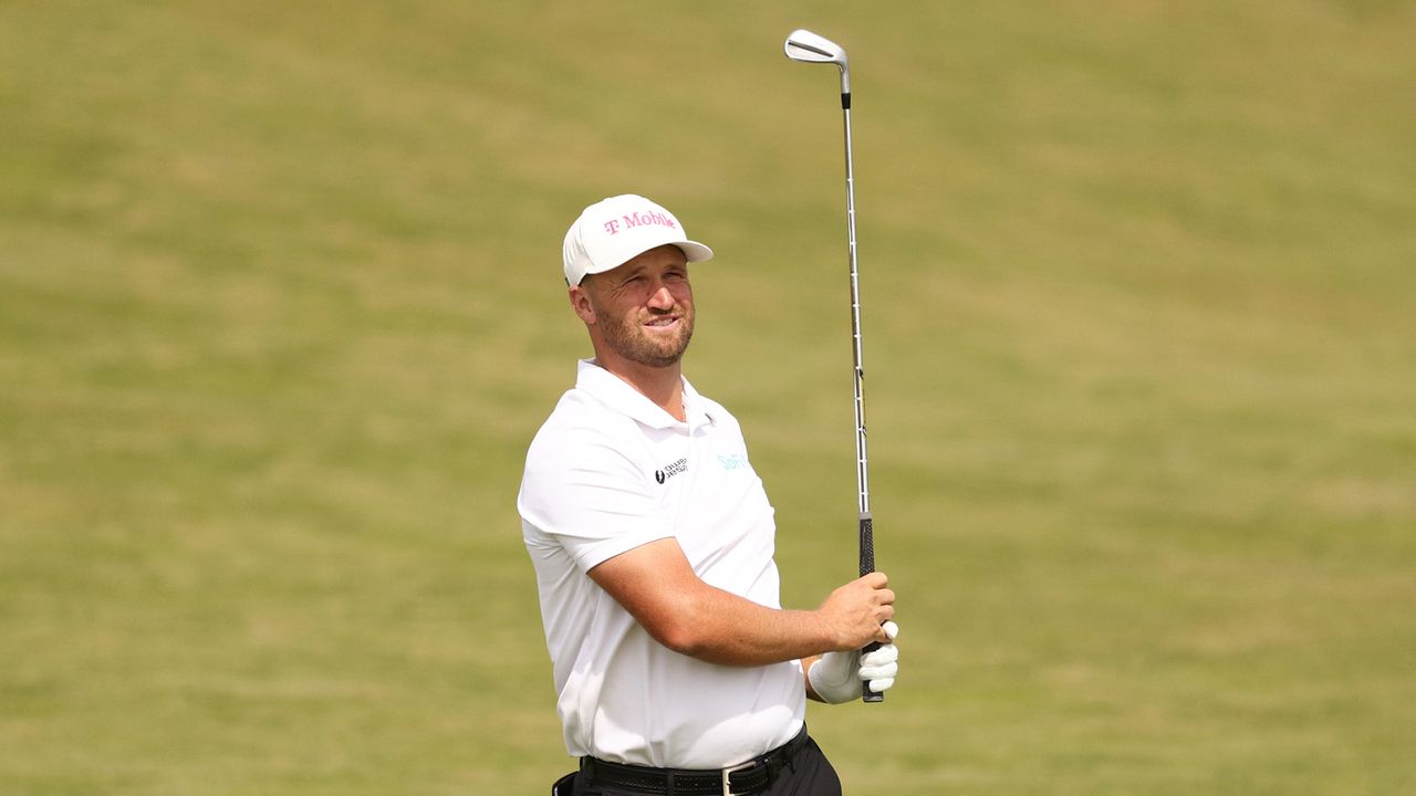 Wyndham Clark hits an iron shot