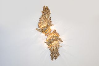 Golden light on wall – Song of the Forest Sconce, by Vikram Goyal for The Future Perfect at Design Miami 2024