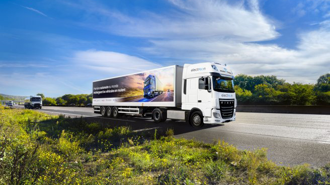 A lorry driving on a highway fitted with inductive coils for wireless charging