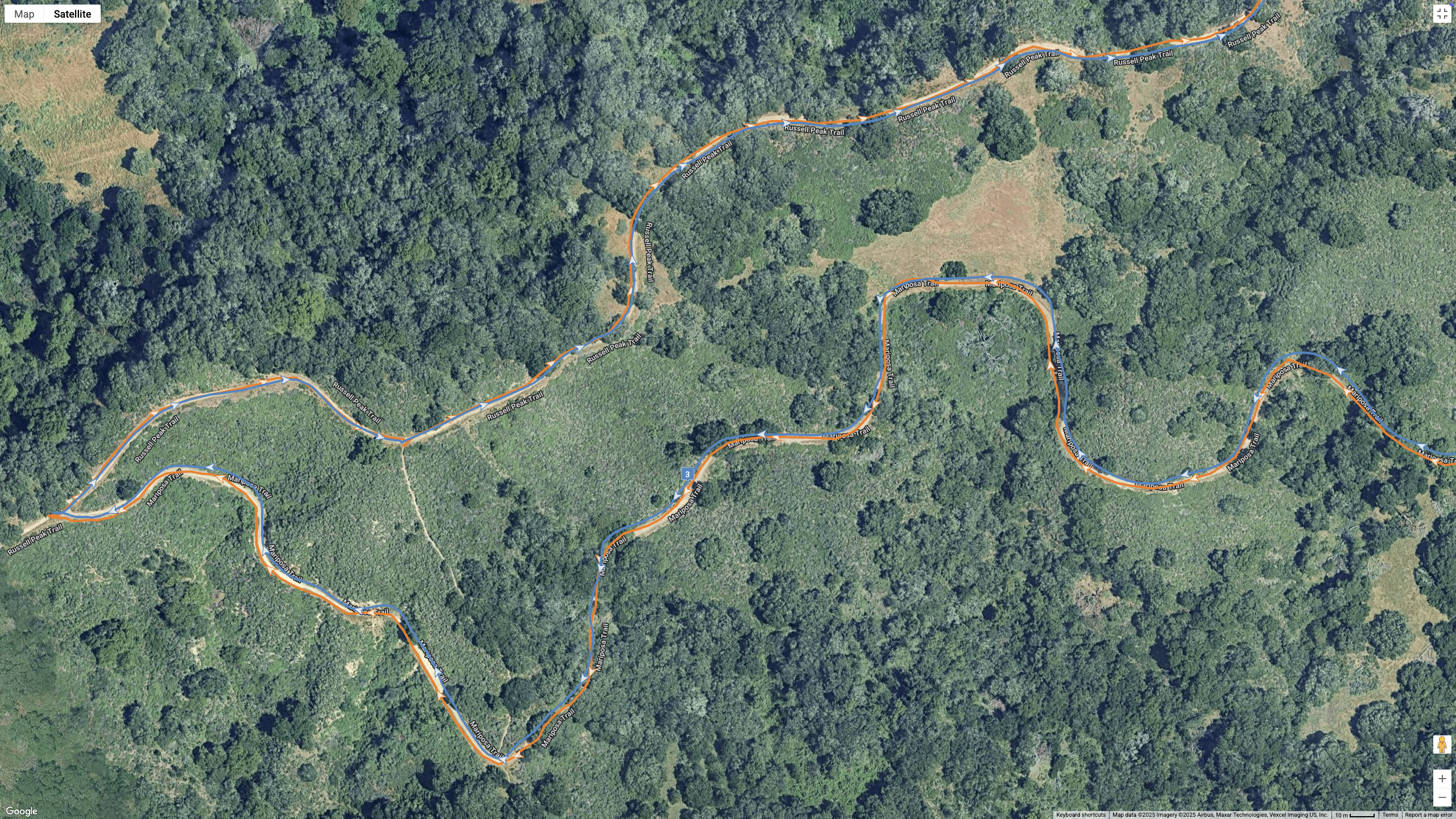 A Google Maps satellite view showing how the COROS APEX 4 (blue) and Garmin Forerunner 970 (orange) compare for GPS-tracked accuracy on a hilly, windy hike.