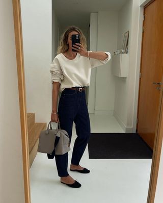 Influencer styles black flat mules with black trousers.